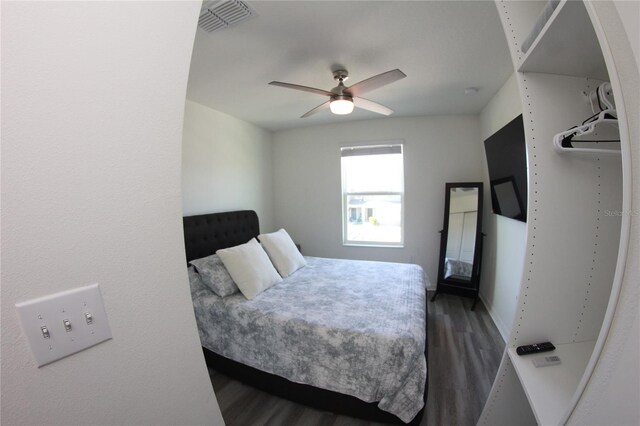 bedroom with dark wood-type flooring and ceiling fan