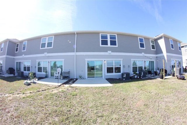 back of house featuring a lawn, a patio, and central air condition unit