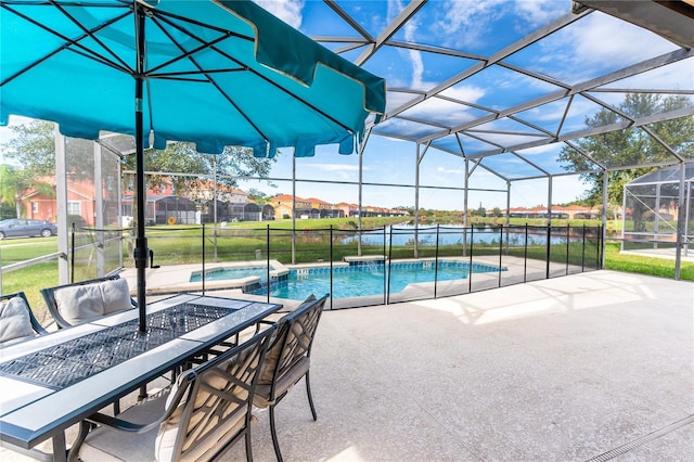 view of pool with an in ground hot tub, a patio, a water view, and glass enclosure