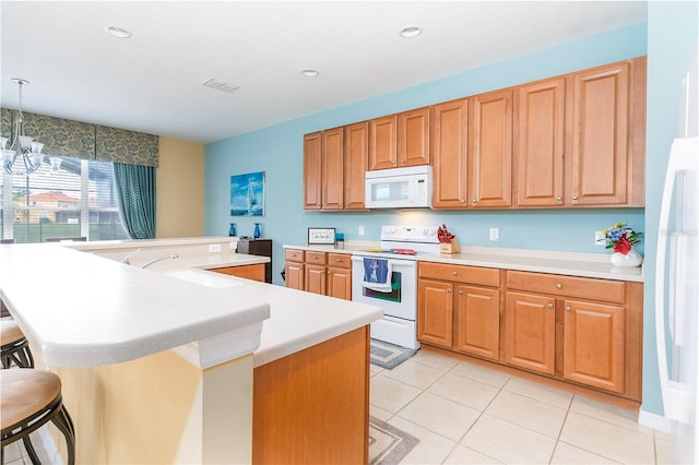 kitchen with light tile patterned floors, white appliances, a kitchen island with sink, a kitchen breakfast bar, and decorative light fixtures