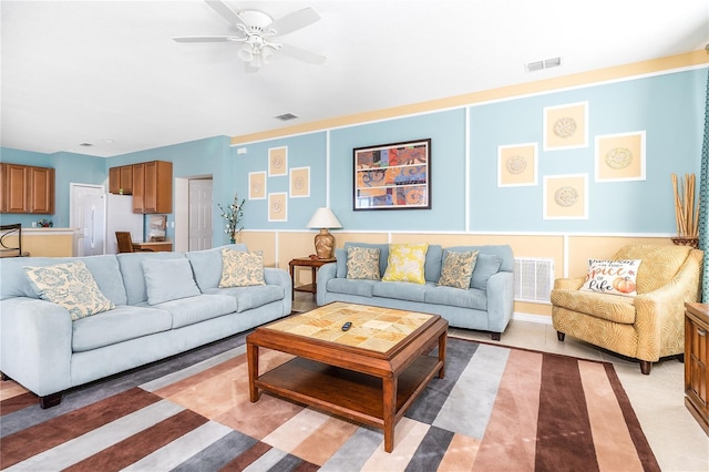 tiled living room with ceiling fan