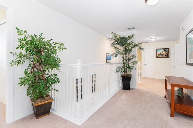 hallway with light colored carpet