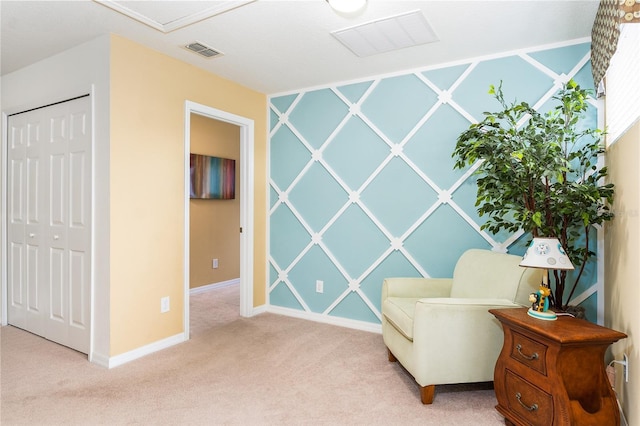 sitting room featuring light carpet