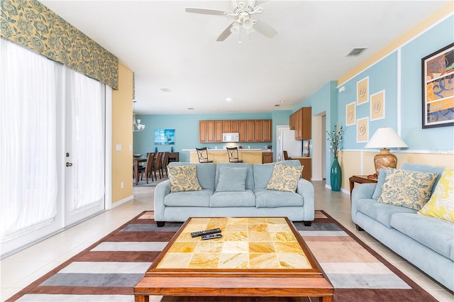 tiled living room with plenty of natural light and ceiling fan