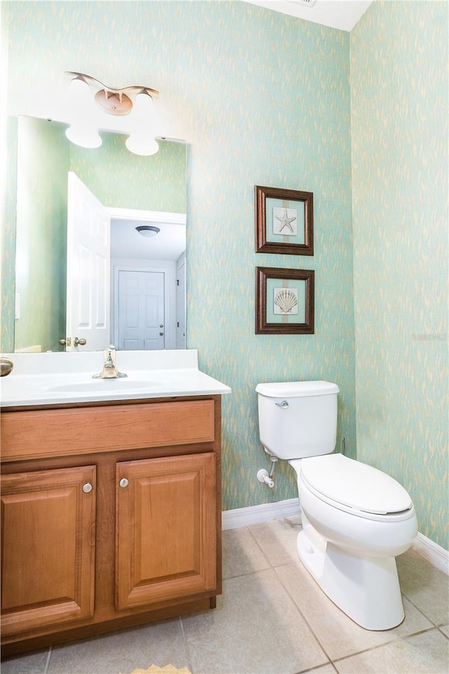 bathroom featuring vanity, toilet, and tile patterned flooring