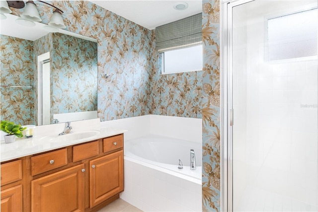 bathroom featuring vanity and tiled bath