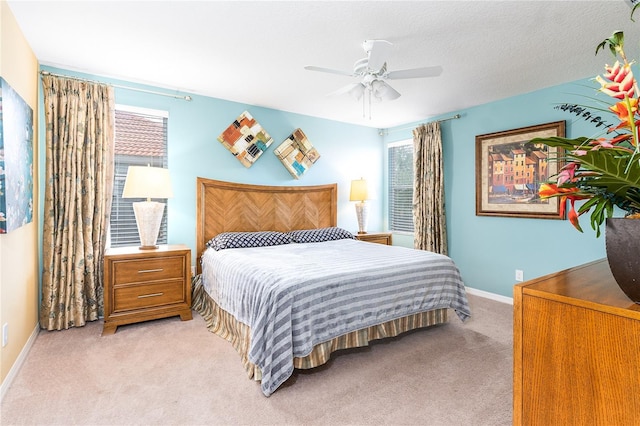 bedroom with light carpet and ceiling fan