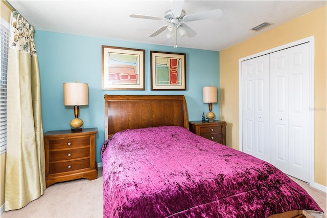 carpeted bedroom with ceiling fan and a closet