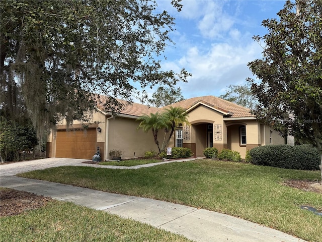 view of front of house featuring a garage and a front lawn