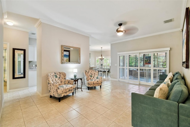 tiled living room featuring crown molding and ceiling fan with notable chandelier