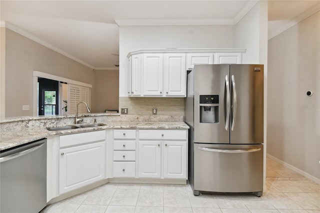 kitchen with sink, ornamental molding, stainless steel appliances, light stone countertops, and white cabinets