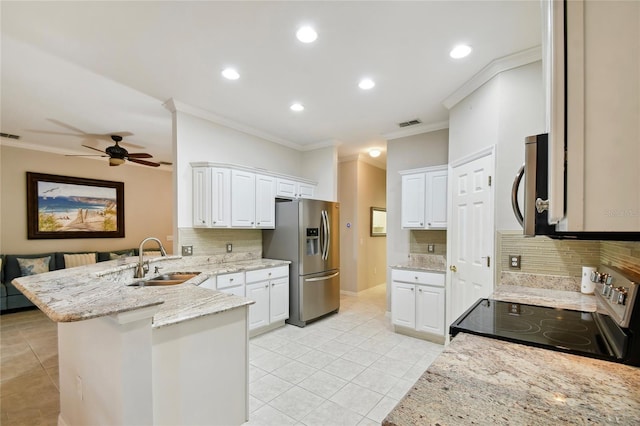 kitchen featuring stainless steel appliances, white cabinetry, and kitchen peninsula