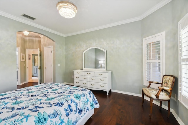 bedroom featuring dark hardwood / wood-style flooring, ornamental molding, and a chandelier