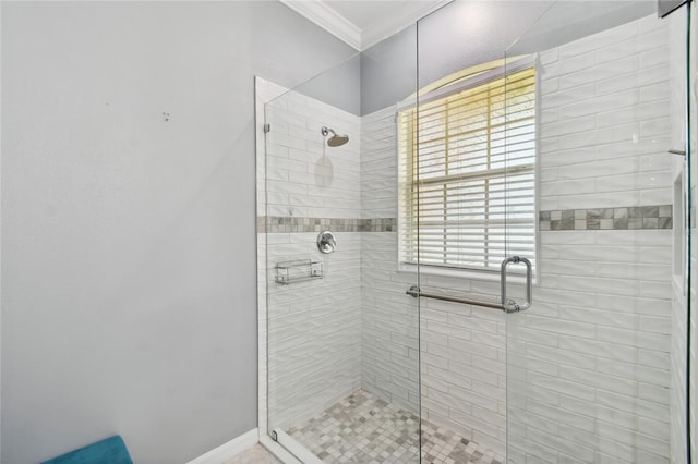 bathroom featuring ornamental molding and an enclosed shower