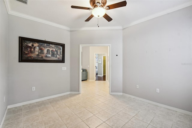 tiled empty room with ceiling fan and ornamental molding