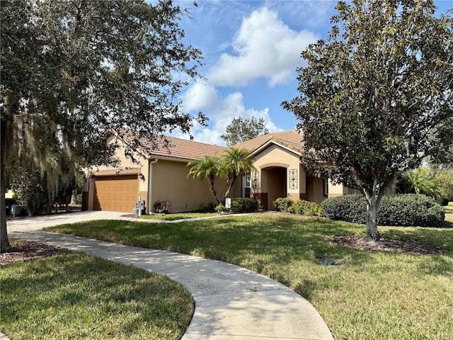 ranch-style home featuring a garage and a front lawn