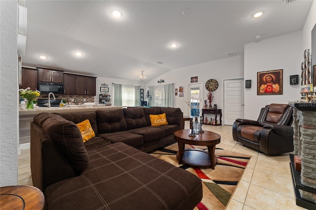 tiled living room with sink and vaulted ceiling