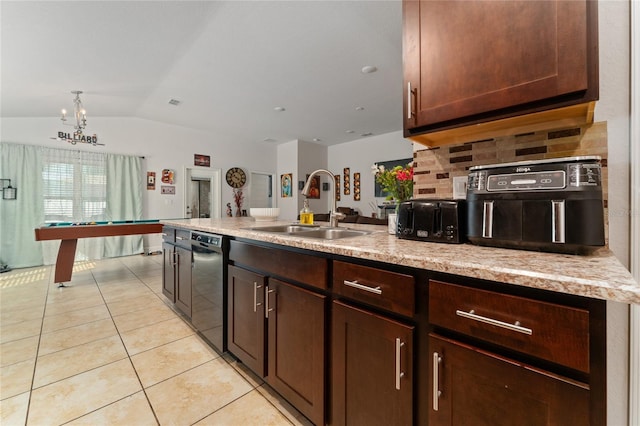 kitchen with dark brown cabinetry, decorative backsplash, vaulted ceiling, light tile patterned floors, and sink