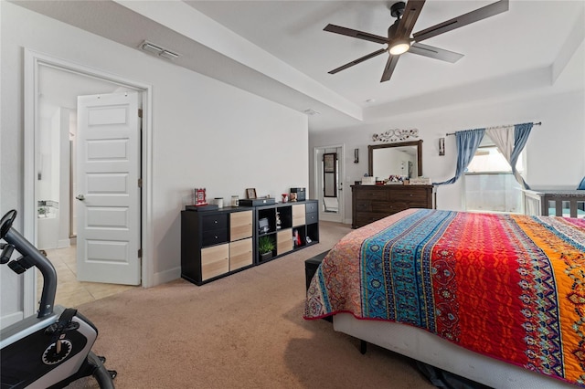 bedroom featuring a tray ceiling and light colored carpet