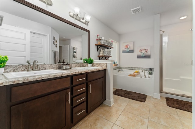 bathroom with tile patterned floors, vanity, and independent shower and bath