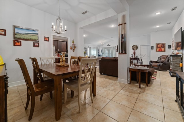 tiled dining room featuring a chandelier