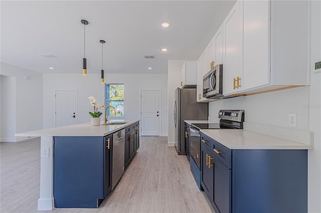 kitchen featuring blue cabinets, sink, white cabinetry, decorative light fixtures, and appliances with stainless steel finishes