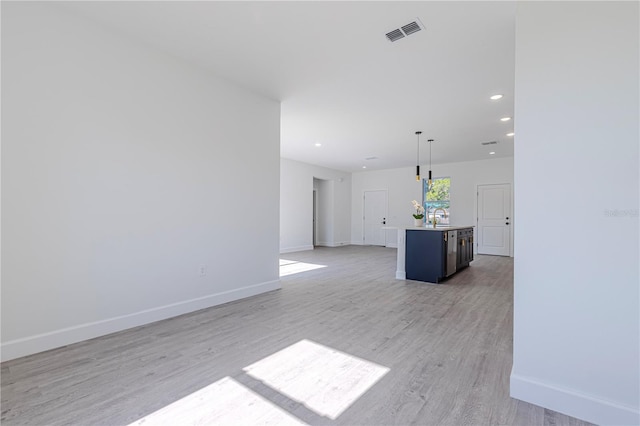 interior space with sink and light hardwood / wood-style floors