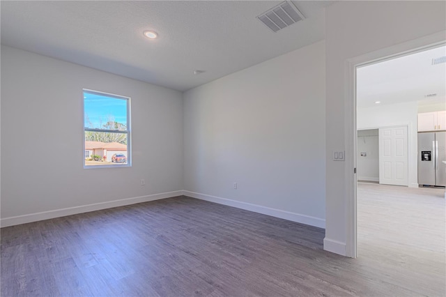 empty room with hardwood / wood-style floors