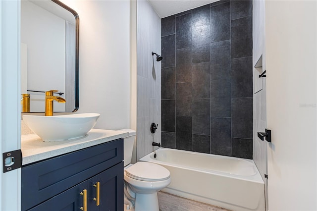 full bathroom featuring vanity, toilet, tiled shower / bath combo, and hardwood / wood-style floors