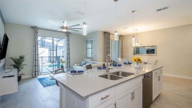 kitchen featuring pendant lighting, sink, dishwasher, white cabinetry, and a center island with sink