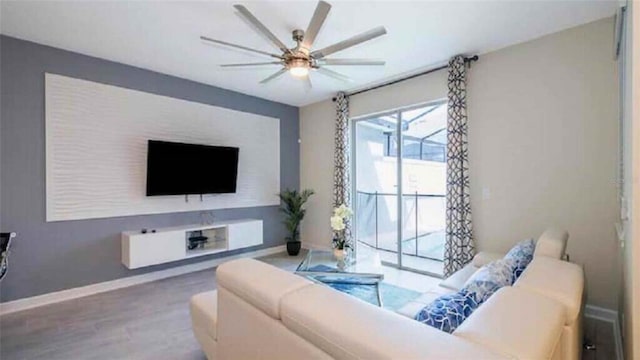 living room with hardwood / wood-style flooring and ceiling fan