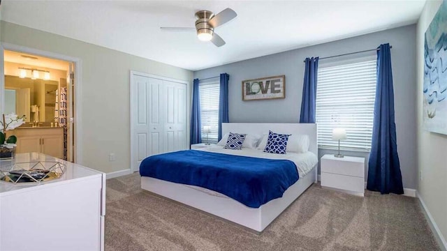 carpeted bedroom featuring a closet, ceiling fan, and ensuite bathroom