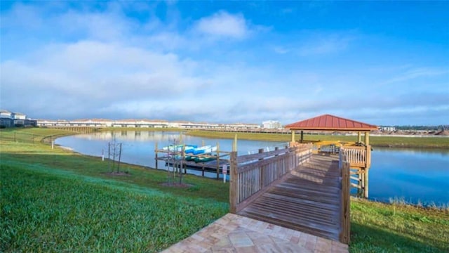 view of dock with a gazebo, a water view, and a yard