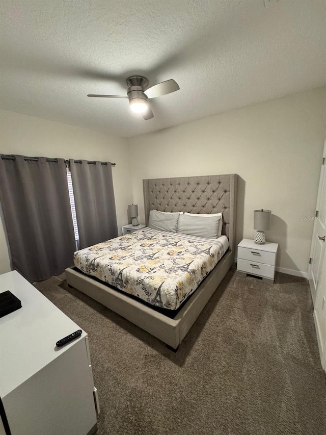 carpeted bedroom featuring ceiling fan and a textured ceiling