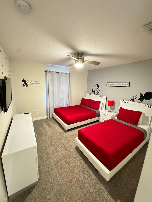 bedroom with dark colored carpet, ceiling fan, and a textured ceiling