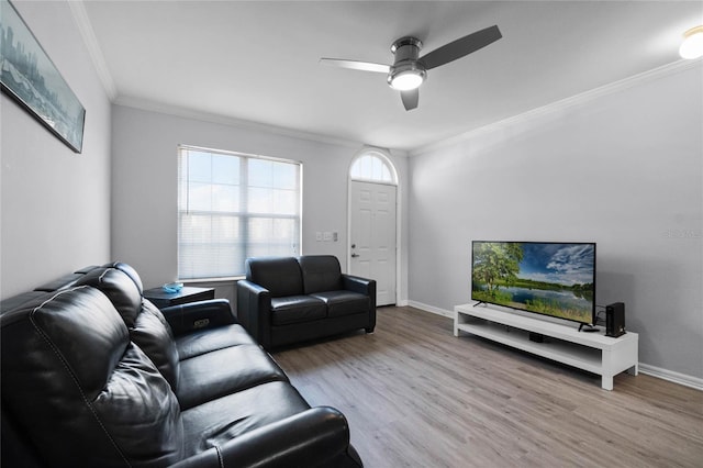 living room featuring ornamental molding, ceiling fan, and light hardwood / wood-style flooring