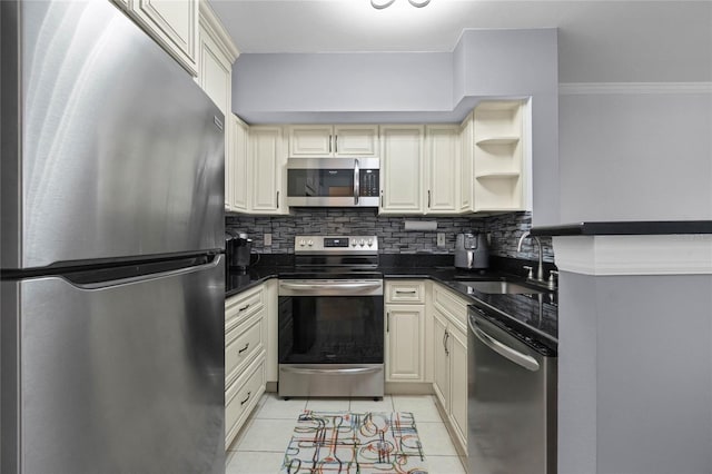 kitchen featuring sink, cream cabinets, stainless steel appliances, and light tile patterned flooring