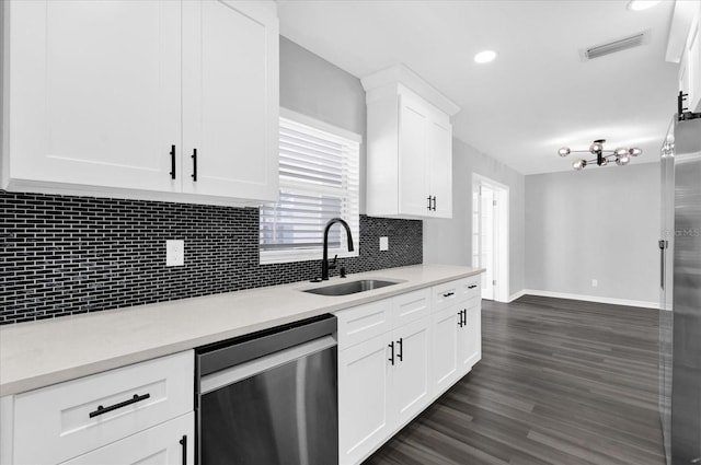 kitchen featuring dark wood-type flooring, sink, white cabinets, stainless steel appliances, and backsplash