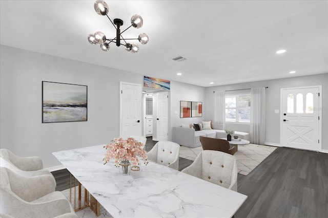 dining room with light hardwood / wood-style flooring and a notable chandelier