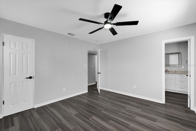 unfurnished bedroom with sink, dark hardwood / wood-style floors, ceiling fan, and ensuite bathroom