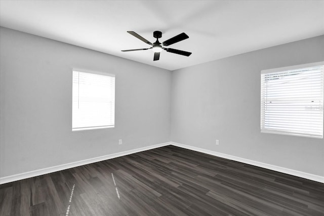 spare room featuring dark wood-type flooring and ceiling fan