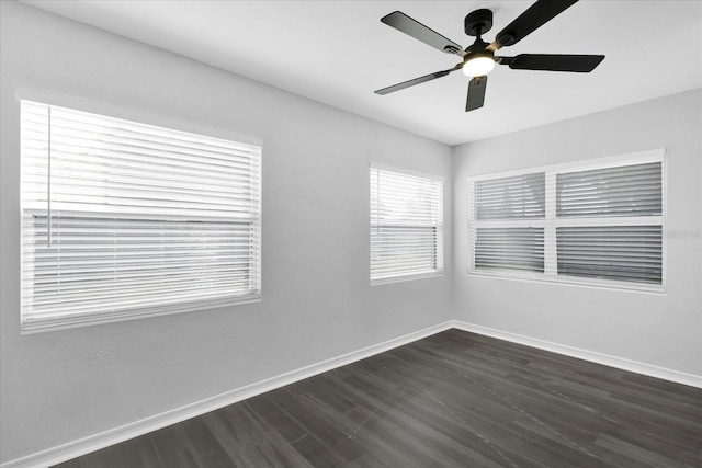 empty room featuring ceiling fan and dark hardwood / wood-style flooring