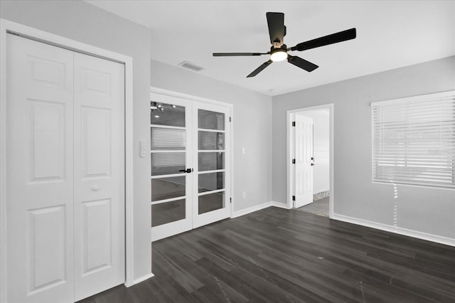 unfurnished room featuring dark wood-type flooring, ceiling fan, and french doors