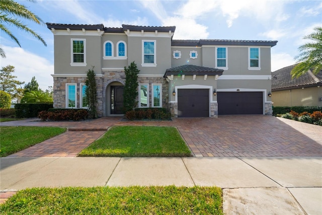 mediterranean / spanish-style house with a garage