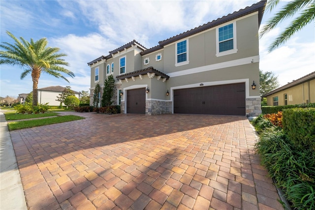 mediterranean / spanish house featuring a garage