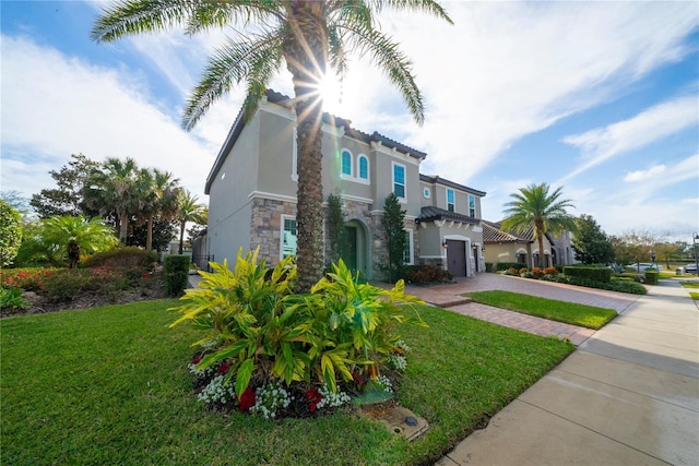 view of front of house featuring a garage and a front yard