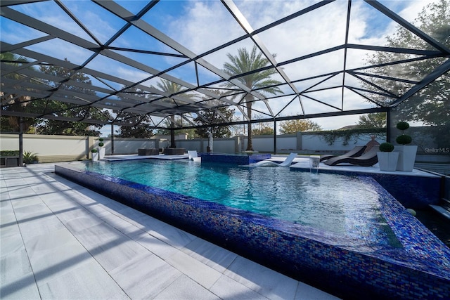 view of swimming pool with pool water feature, a patio, and glass enclosure