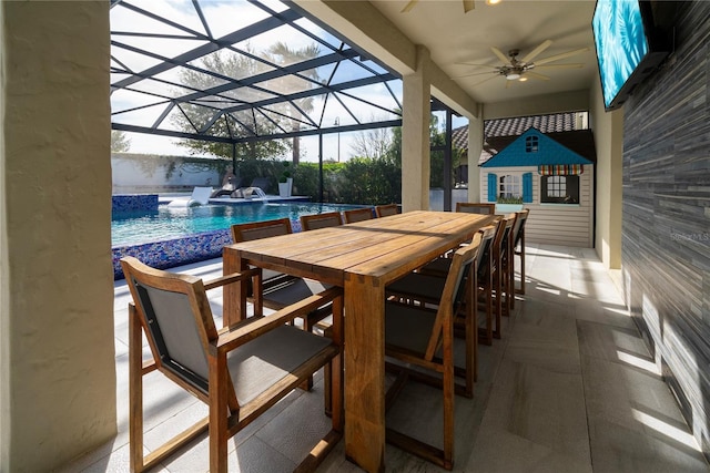 view of patio / terrace with an outbuilding, ceiling fan, and a lanai