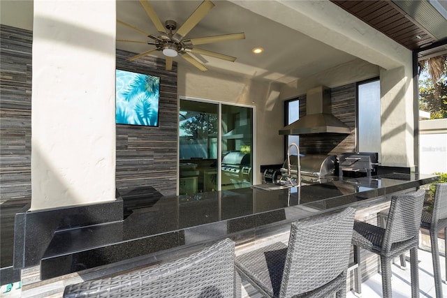 view of patio / terrace featuring a grill, ceiling fan, and a bar