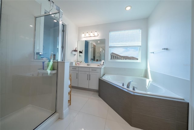 bathroom with vanity, tile patterned floors, and plus walk in shower